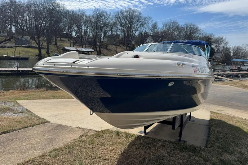 Slide: The Image of 2006 Sea Ray 240 Sundeck boat on trailer near a lakeside dock. - 9
