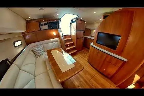 Slide: The Image of Luxurious interior of 2006 Tiara Yachts 4300 Sovran with elegant wood finishes and plush seating. - 10