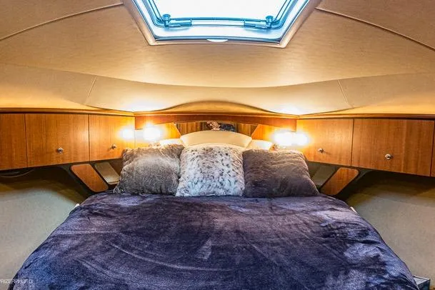Slide: The Image of Luxurious cabin interior of 2007 Tiara Yachts 4300 Sovran with plush bedding and ambient lighting. - 11