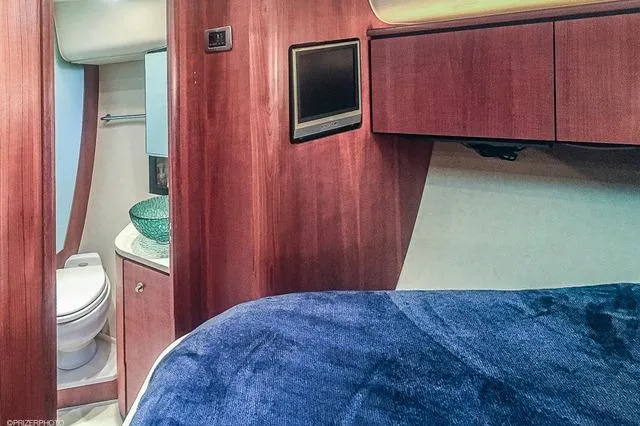 Slide: The Image of 2007 Tiara Yachts 4300 Sovran interior with bed, TV, and bathroom. - 12