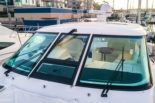 Slide: The Image of 2007 Tiara Yachts 4300 Sovran with sleek windshield and marina backdrop. - 17