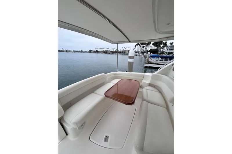 Slide: The Image of 2006 Tiara Yachts 4300 Sovran cockpit with seating and table, overlooking marina. - 18