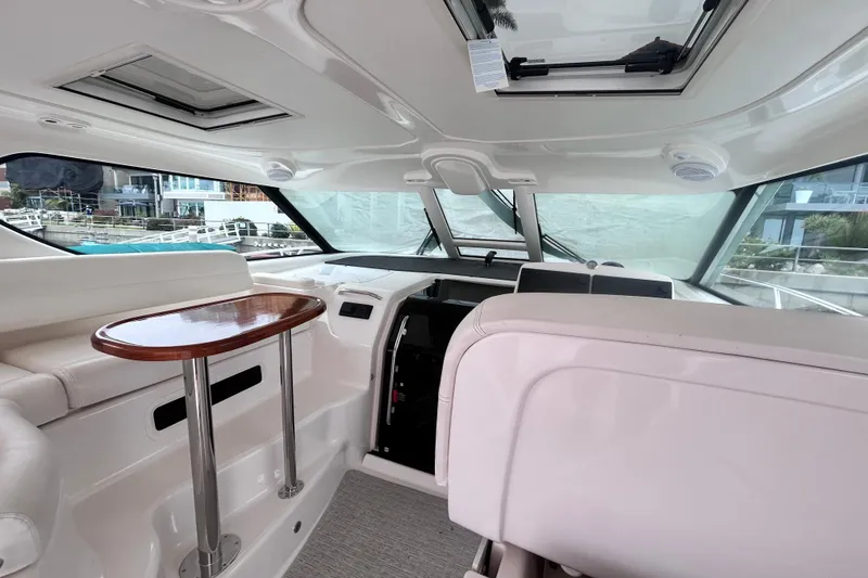 Slide: The Image of Interior of 2006 Tiara Yachts 4300 Sovran with sleek seating and wooden table. - 22