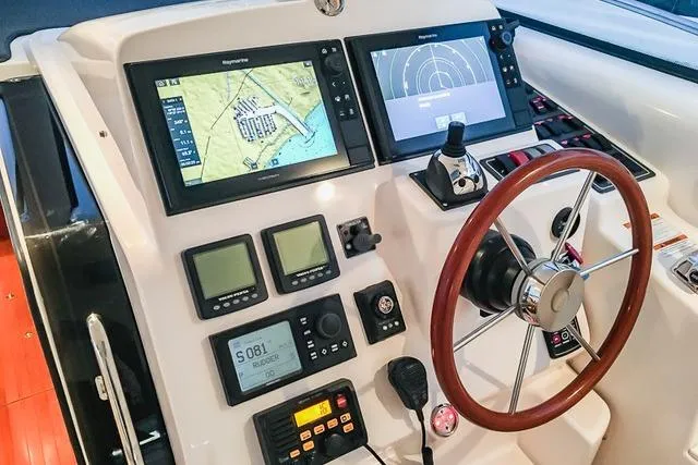 Slide: The Image of Helm of 2007 Tiara Yachts 4300 Sovran with navigation displays and controls. - 5
