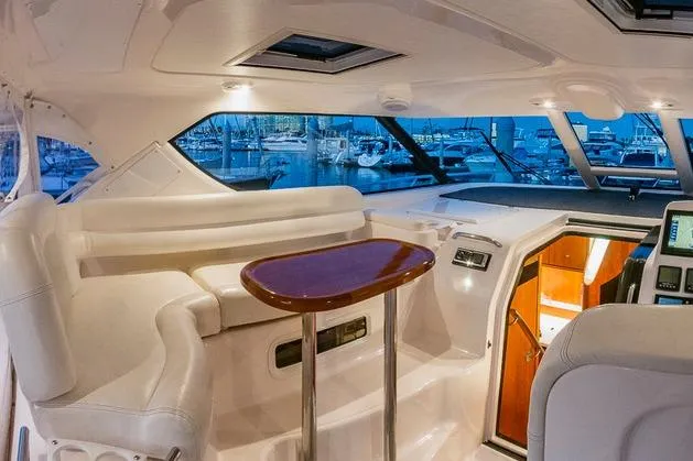 Slide: The Image of Interior of 2007 Tiara Yachts 4300 Sovran, featuring elegant seating and a polished table. - 6