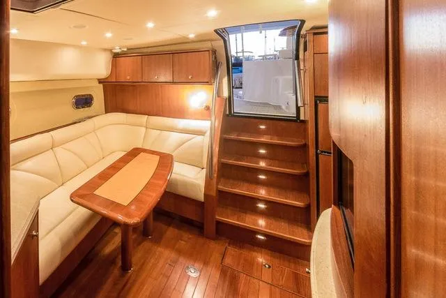 Slide: The Image of 2007 Tiara Yachts 4300 Sovran interior with elegant wood finish and cozy seating area. - 8