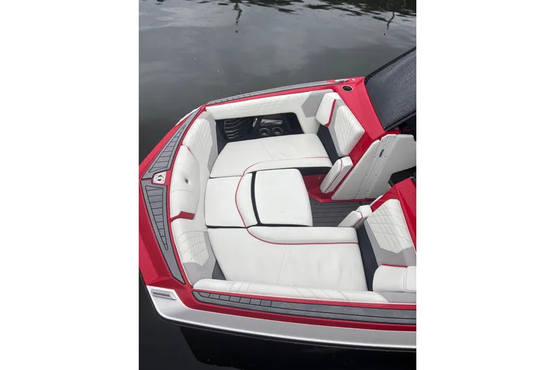 Slide: The Image of 2023 Nautique Super Air Nautique G23 boat interior with red and white seating. - 7