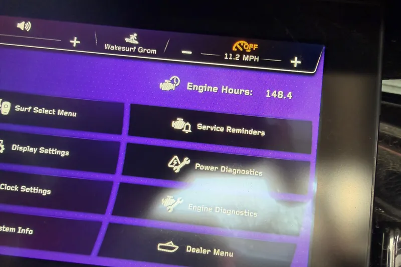Slide: The Image of Touchscreen display of 2023 Nautique Super Air Nautique G23 showing engine hours and settings menu. - 8