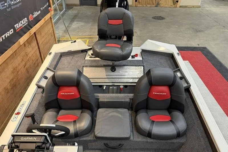 Slide: The Image of 2025 Tracker Pro Team 175 boat interior with three cushioned seats and Garmin equipment. - 8