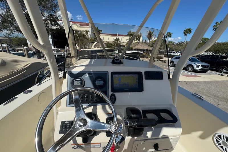 Slide: The Image of 2023 Scout 195 Sportfish boat dashboard with steering wheel and navigation system. - 10