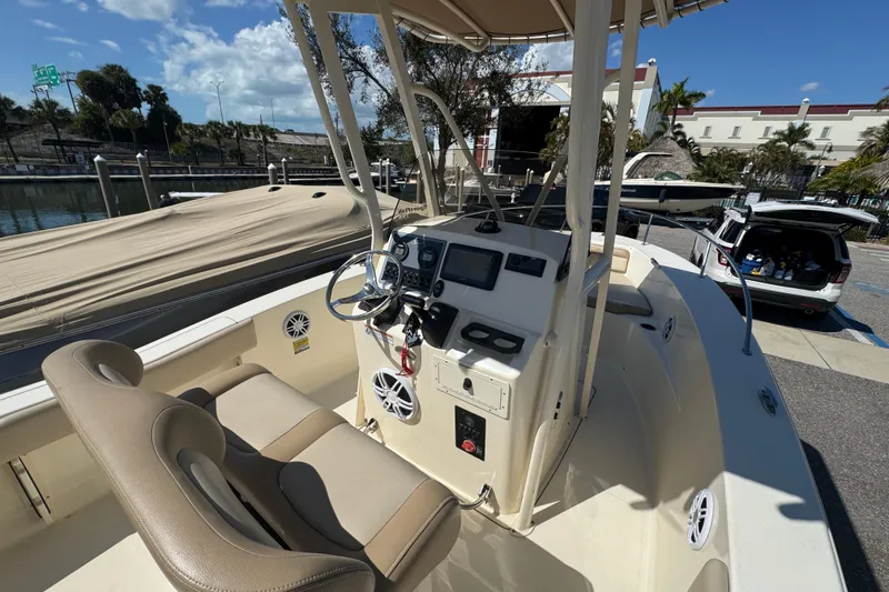 Slide: The Image of 2023 Scout 195 Sportfish boat interior with steering console and seating. - 11
