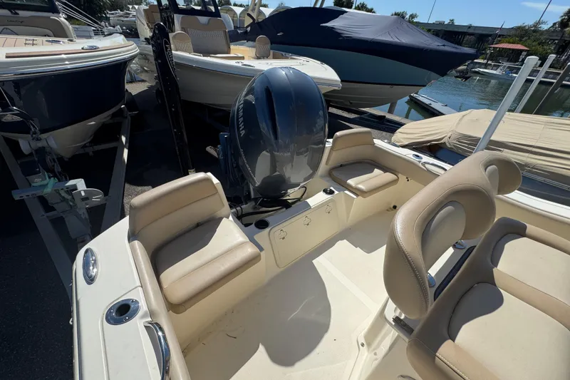 Slide: The Image of 2023 Scout 195 Sportfish boat interior with seating and outboard motor. - 14