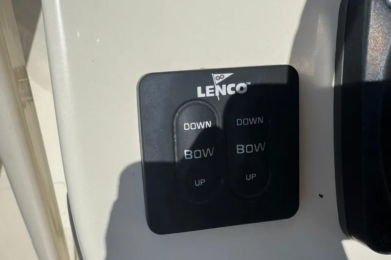 Slide: The Image of Lenco trim tab control panel on 2023 Scout 195 Sportfish boat. - 16