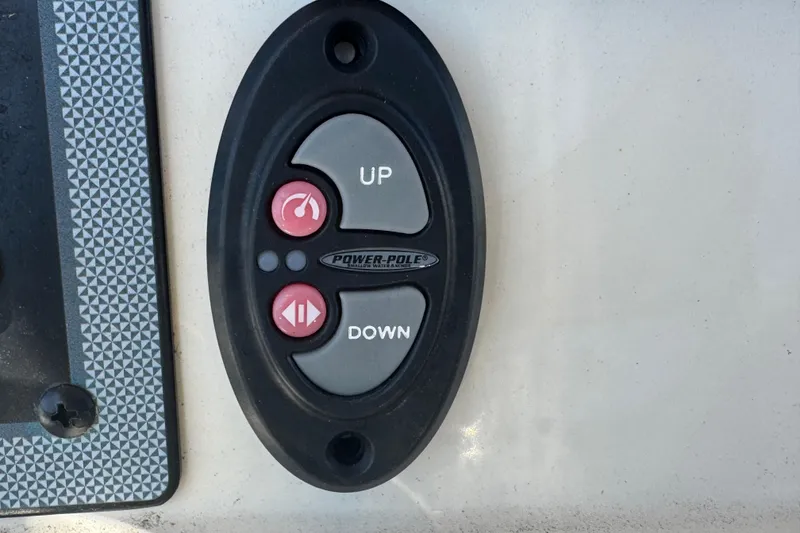 Slide: The Image of Power-Pole control panel on 2023 Scout 195 Sportfish boat, featuring up and down buttons. - 17