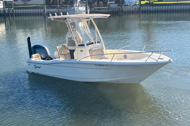 Slide: The Image of 2023 Scout 195 Sportfish boat on calm water, featuring sleek design and modern amenities. - 3