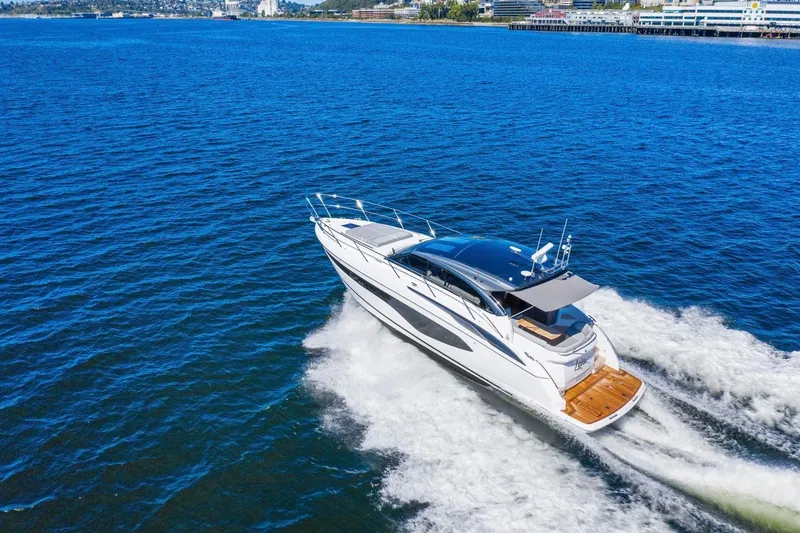 Slide: The Image of The 2020 Princess V50 speeds across blue water, featuring a sleek, modern design. - 2