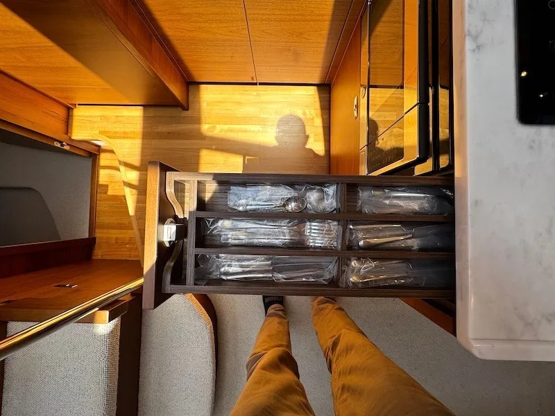 Slide: The Image of View of a 2020 Princess V50 yacht kitchen with an open cutlery drawer. - 29