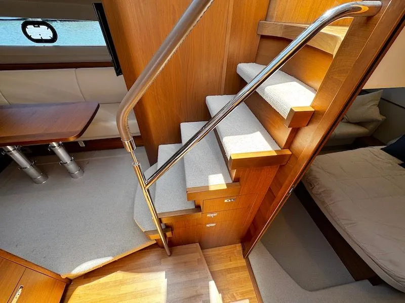 Slide: The Image of Interior of a Princess V50 yacht with stairs and seating area. - 32