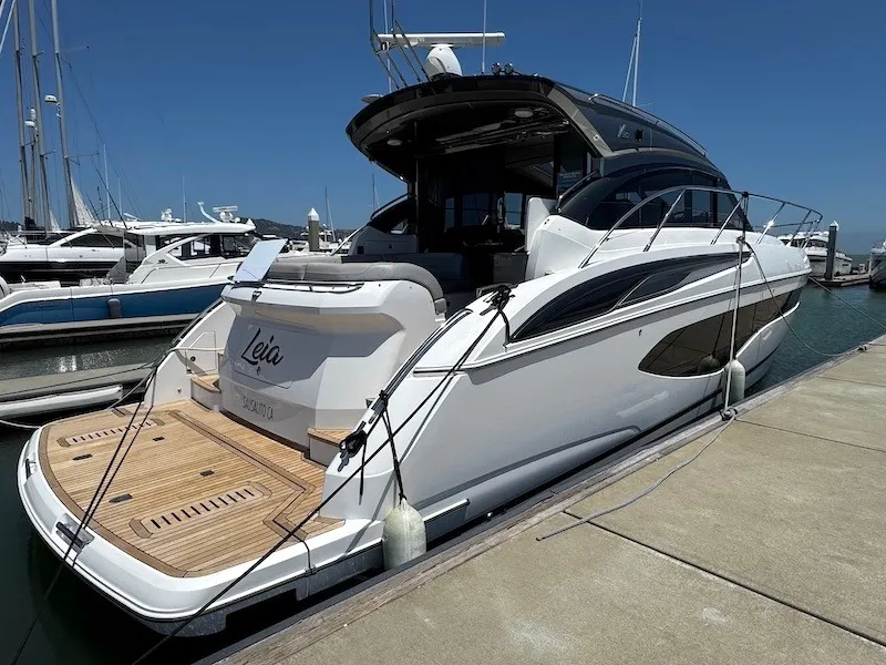 Slide: The Image of A luxury motor yacht docked, featuring a sleek white hull and spacious deck. - 6