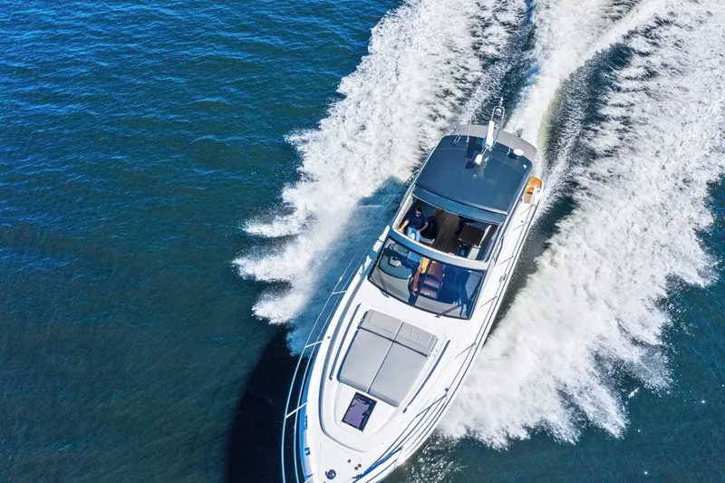 Slide: The Image of A luxury motor yacht speeds across the water, leaving a white wake behind. - 7