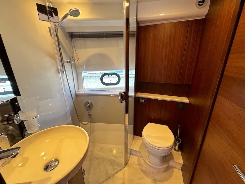 Slide: The Image of The image shows an elegant yacht bathroom with a shower, sink, and toilet. - 35