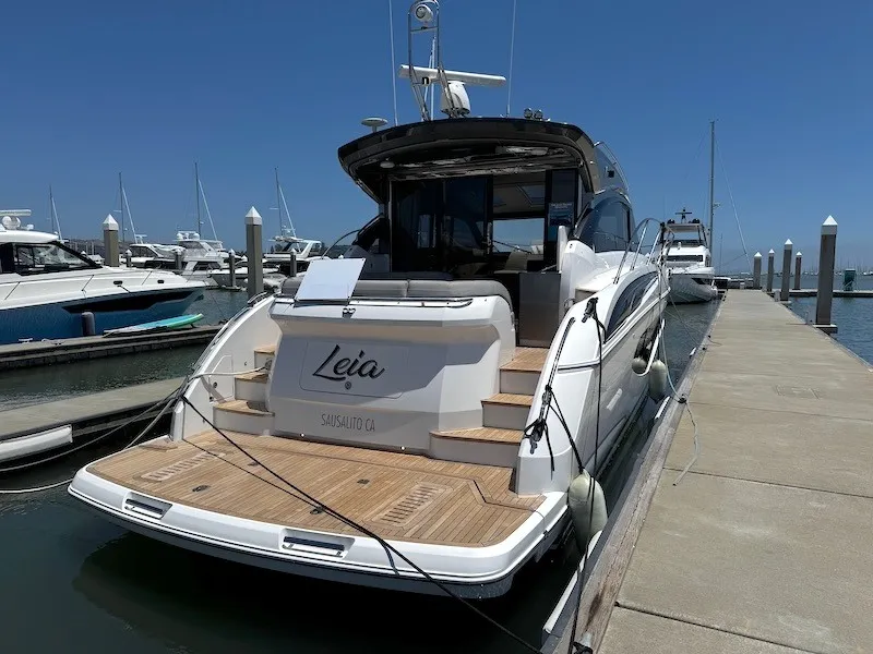 Slide: The Image of A luxury yacht named Leia is docked on a sunny pier. It features sleek design and spacious platform. - 4