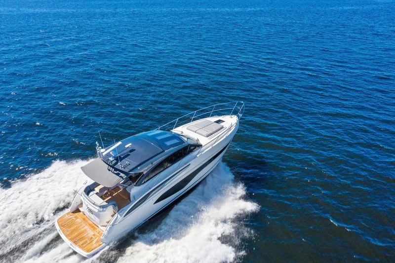 Slide: The Image of The 2020 Princess V50 speeds across blue water, featuring a sleek, modern design. - 8