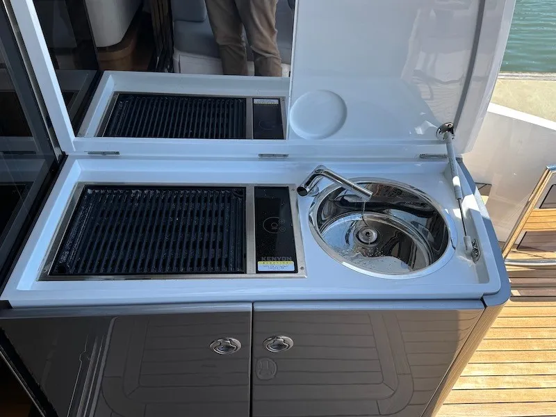 Slide: The Image of The 2020 Princess V50 features an outdoor kitchen with a grill and sink. - 13