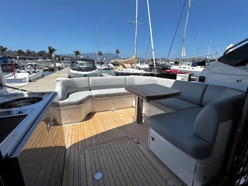 Slide: The Image of The image shows the cockpit of a 2020 Princess V50 yacht with elegant seating and a table. - 11