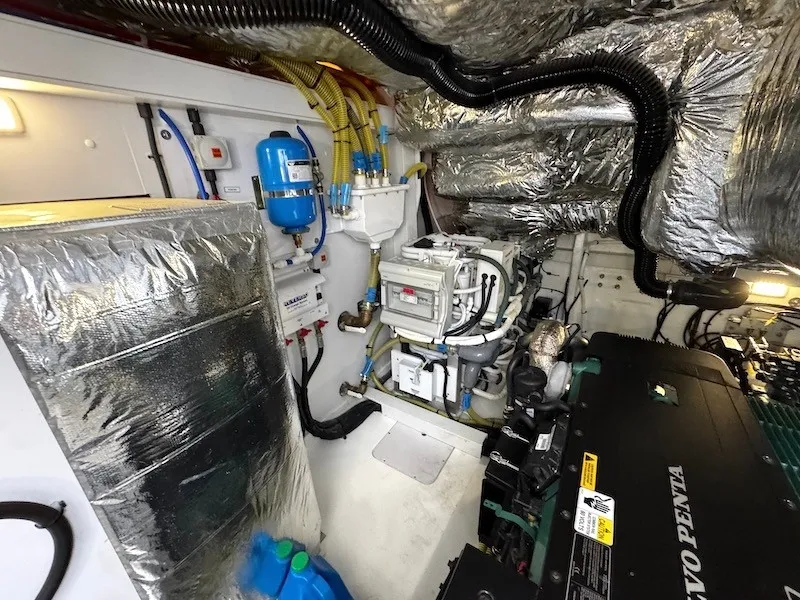 Slide: The Image of The engine room of a 2020 Princess V50 features a Volvo Penta engine and insulation. - 46