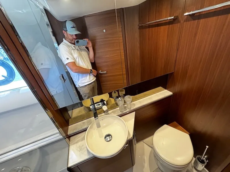 Slide: The Image of A modern yacht bathroom with wood paneling, sink, and toilet. - 41