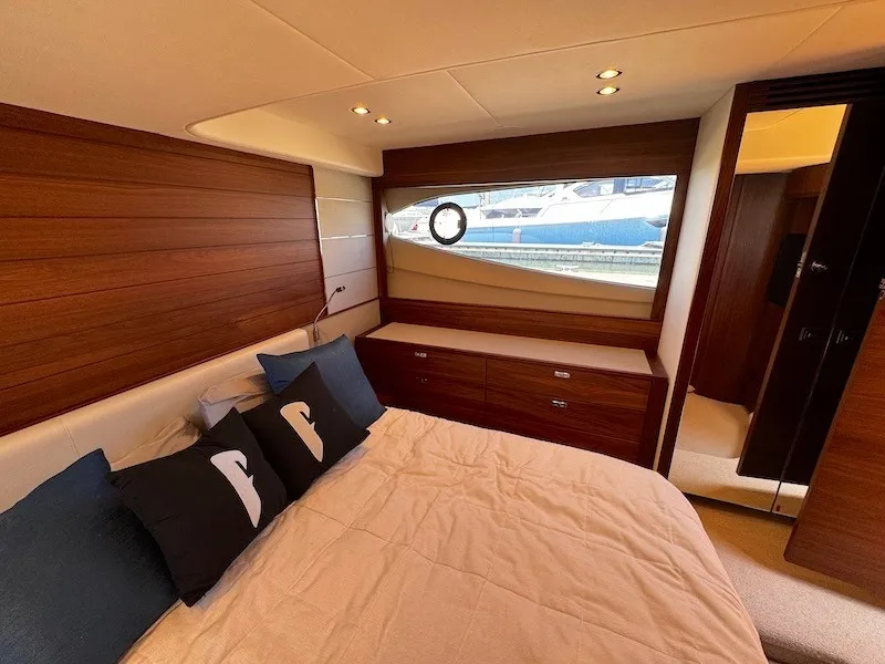 Slide: The Image of Luxurious cabin with wooden walls, a large bed, and windows overlooking the water. - 38