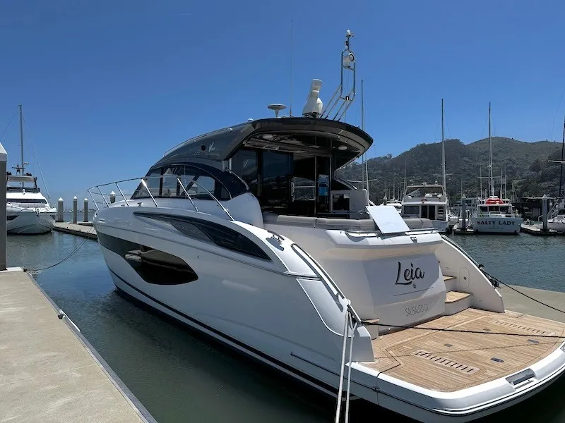Slide: The Image of A sleek white yacht docked, featuring a modern design and spacious deck area. - 3