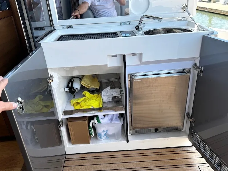 Slide: The Image of The 2020 Princess V50's onboard kitchen features a fridge, sink, and storage space. - 14