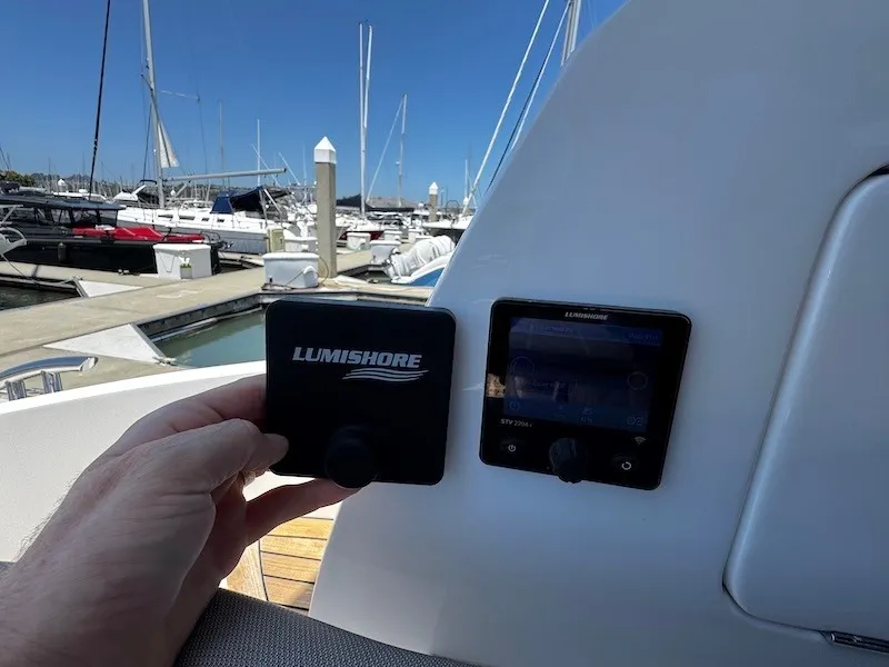 Slide: The Image of A control device and screen on a boat, with yachts in the harbor background. - 12
