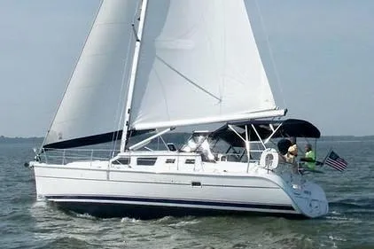 Slide: The Image of 2007 Hunter 44 Deck Salon sailboat cruising on open water with sails fully raised. - 0