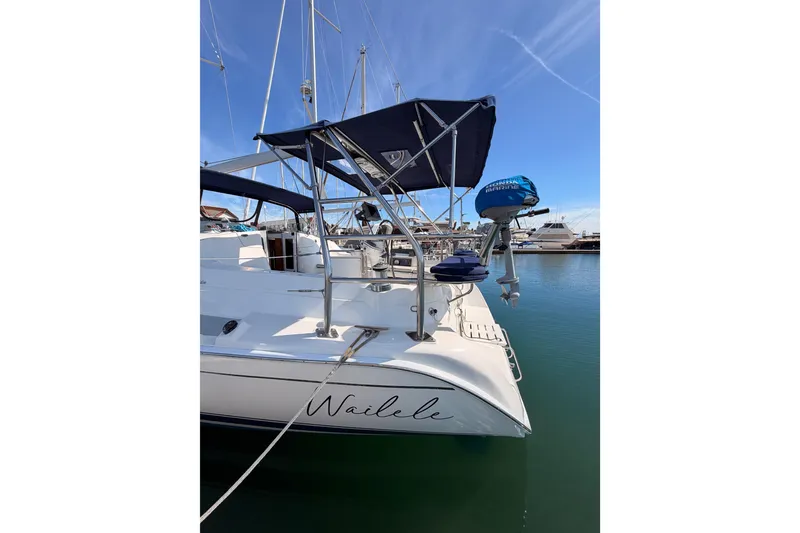 Slide: The Image of Hunter 44 Deck Salon 2007 sailboat docked in marina, featuring sleek design and blue canopy. - 10