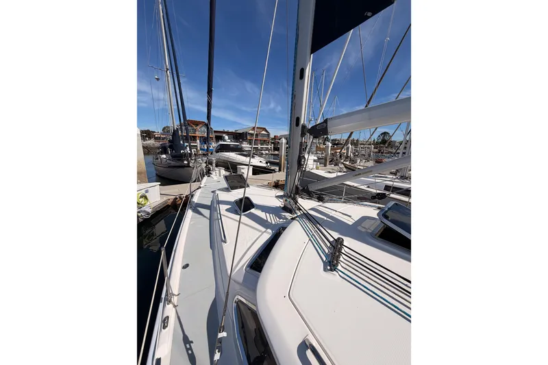 Slide: The Image of 2007 Hunter 44 Deck Salon sailboat docked at marina, showcasing deck and rigging. - 14
