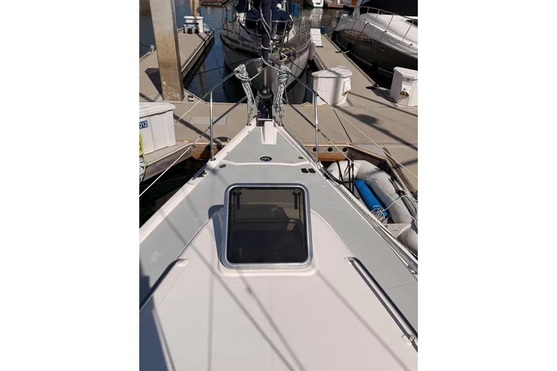 Slide: The Image of 2007 Hunter 44 Deck Salon sailboat docked, showcasing deck and hatch details. - 15