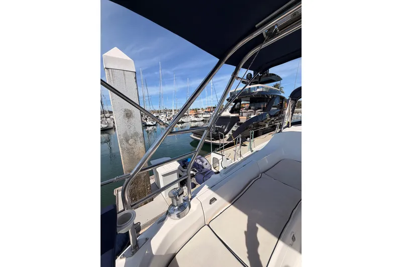 Slide: The Image of 2007 Hunter 44 Deck Salon sailboat docked at marina, featuring spacious seating and sleek design. - 27