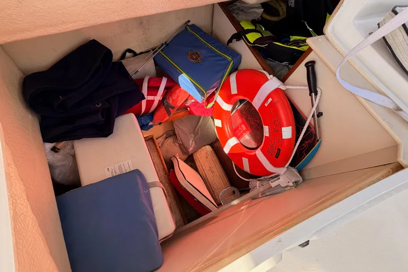Slide: The Image of Storage compartment of 2007 Hunter 44 Deck Salon with life ring and gear. - 29