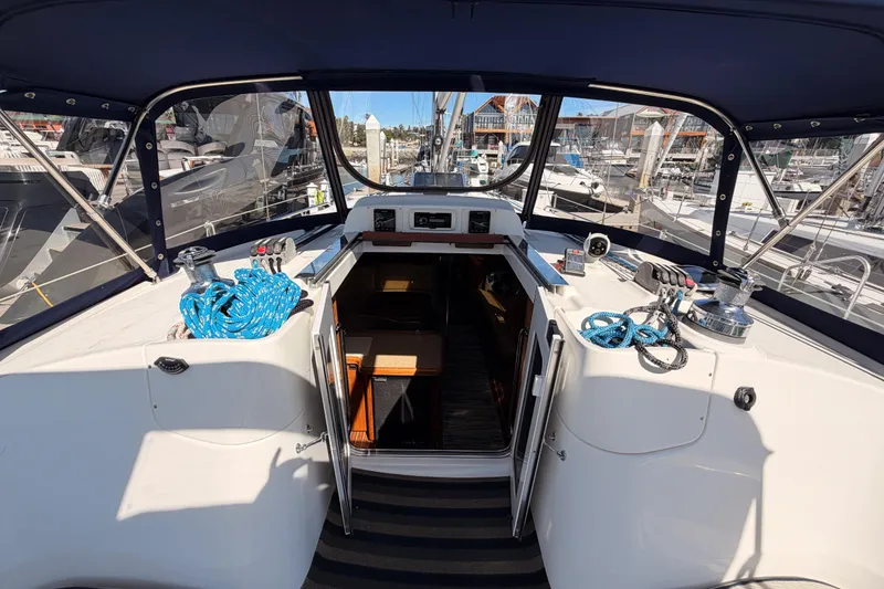 Slide: The Image of 2007 Hunter 44 Deck Salon yacht cockpit with blue ropes and marina view. - 30
