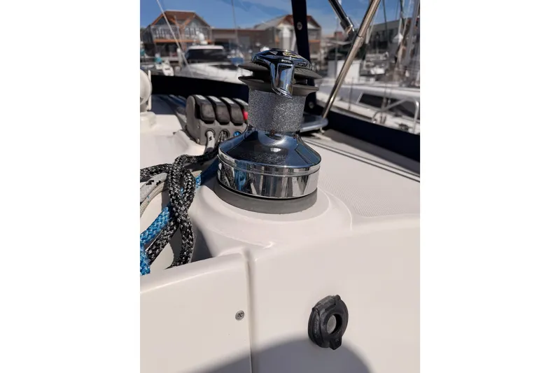 Slide: The Image of Winch on 2007 Hunter 44 Deck Salon sailboat, with ropes and marina background. - 31
