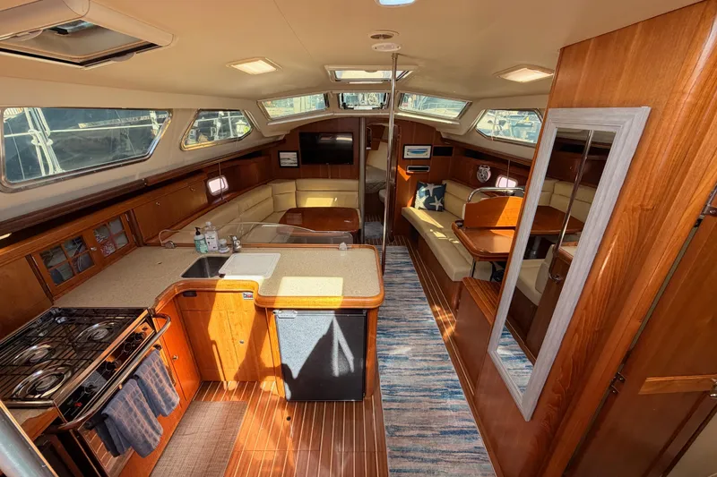Slide: The Image of Luxurious interior of 2007 Hunter 44 Deck Salon yacht with modern kitchen and seating area. - 34