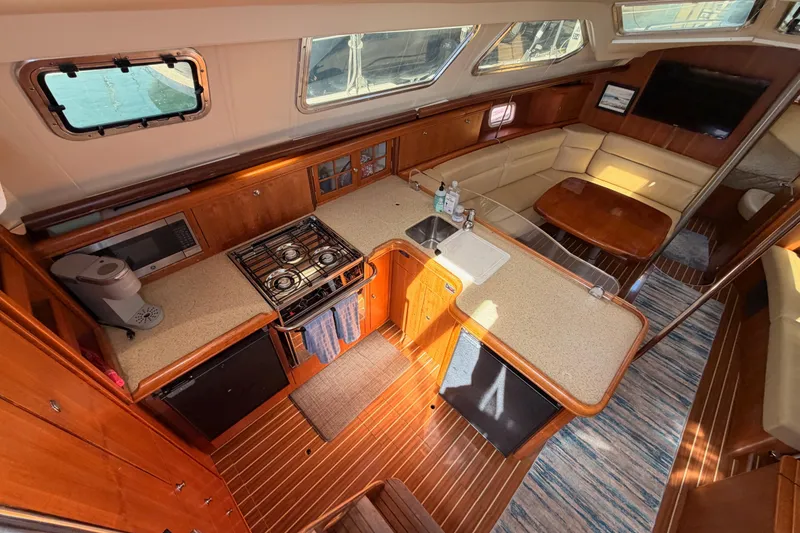 Slide: The Image of Luxurious 2007 Hunter 44 Deck Salon interior with kitchen and seating area. - 35