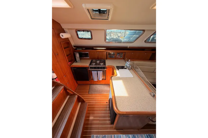 Slide: The Image of Interior of 2007 Hunter 44 Deck Salon yacht with kitchen and seating area. - 36