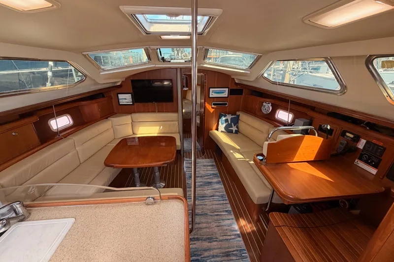 Slide: The Image of Luxurious interior of 2007 Hunter 44 Deck Salon yacht with elegant wood finishes and ample seating. - 44