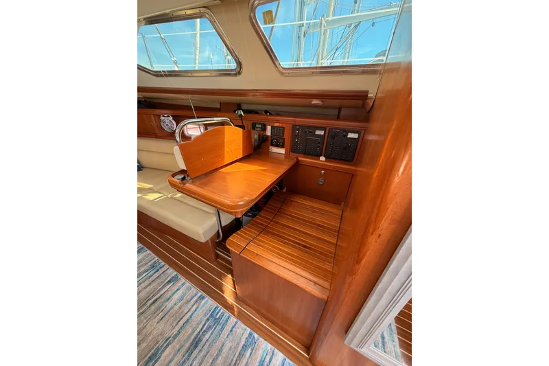 Slide: The Image of 2007 Hunter 44 Deck Salon interior with wooden table and control panels. - 45