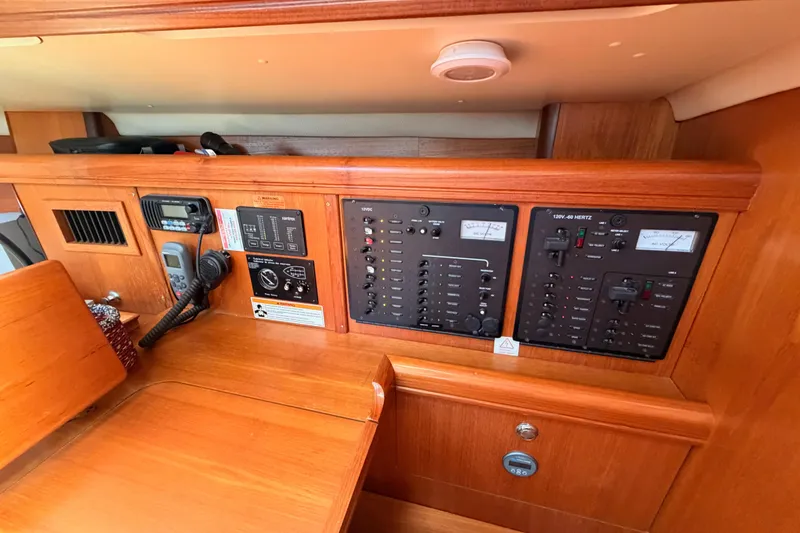 Slide: The Image of Control panel of a 2007 Hunter 44 Deck Salon yacht, featuring navigation and communication equipment. - 46