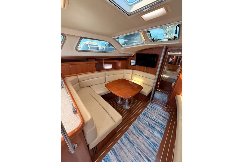 Slide: The Image of 2007 Hunter 44 Deck Salon interior with elegant seating and wooden table. - 47